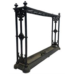 Coalbrookdale design - late 19th century black finish cast iron stick stand, the rectangular top set with one row of nine circular divisions, cluster column upright supports united by scrolled decoration, on moulded skirted base with two lift-out drip-trays, with registration lozenge to underneath 