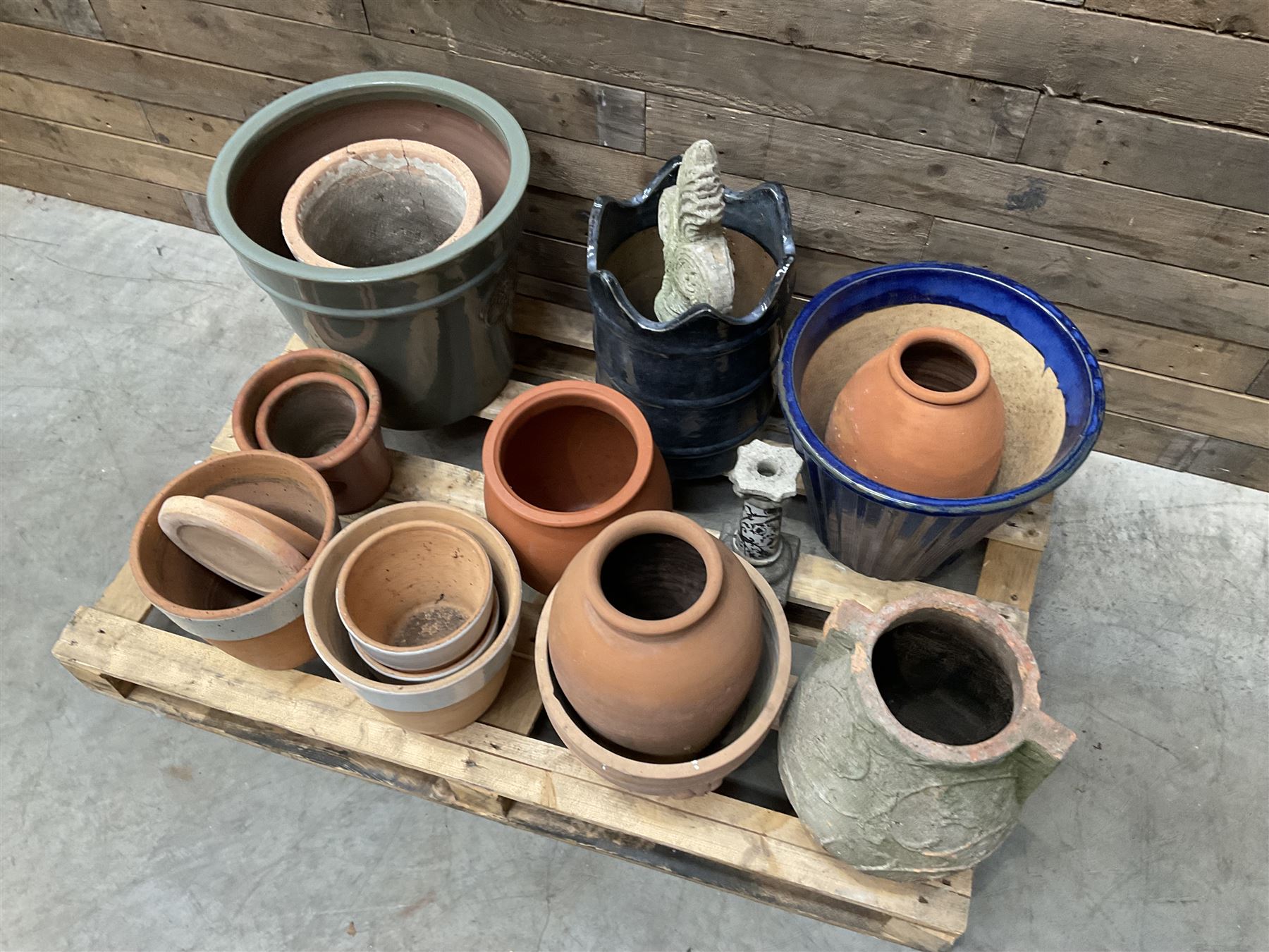A quantity of various terracotta and glazed planters