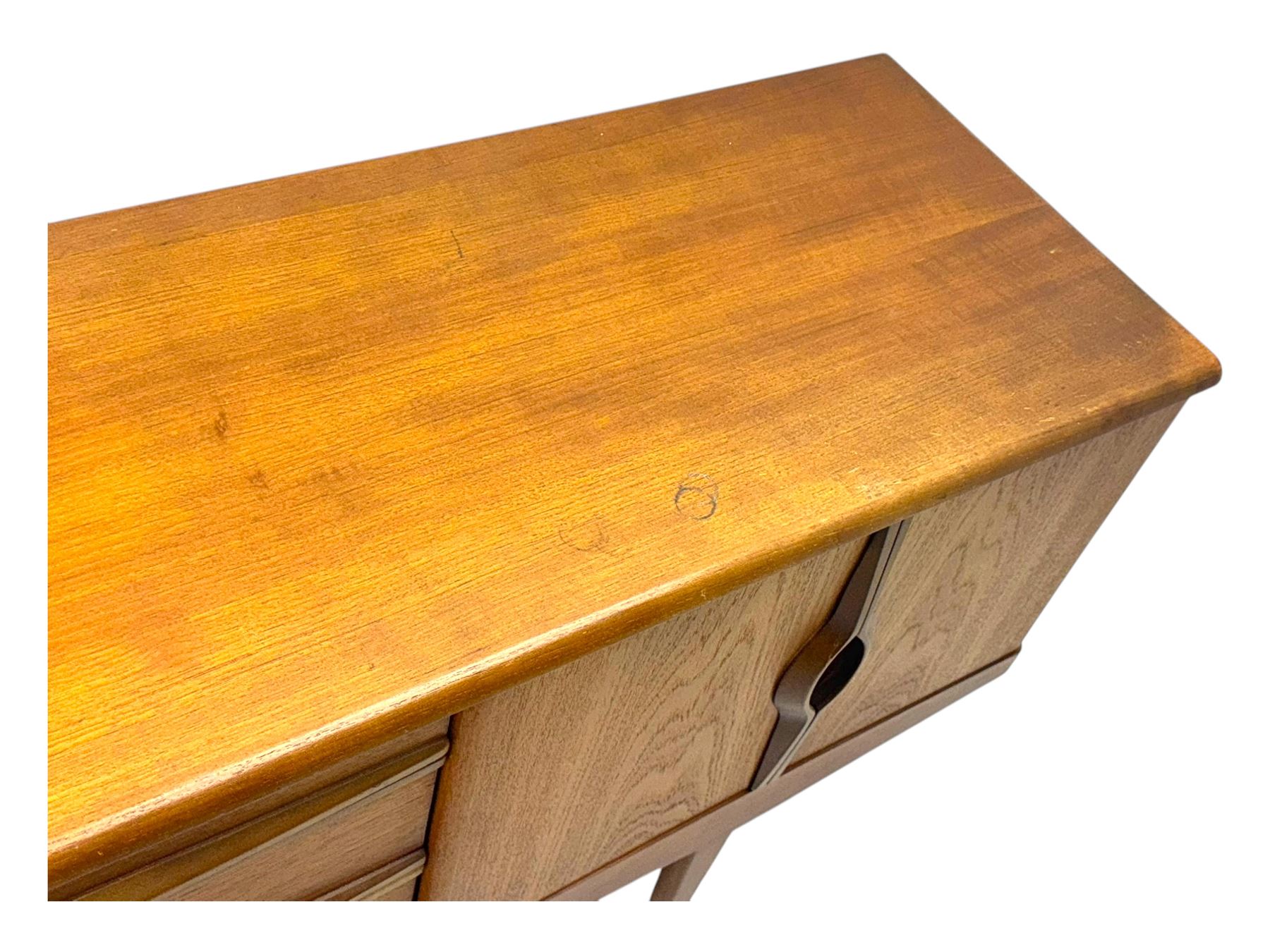 Stonehill - mid-20th century teak sideboard, three central drawers flanked by concertina cupboard doors, on tapering supports