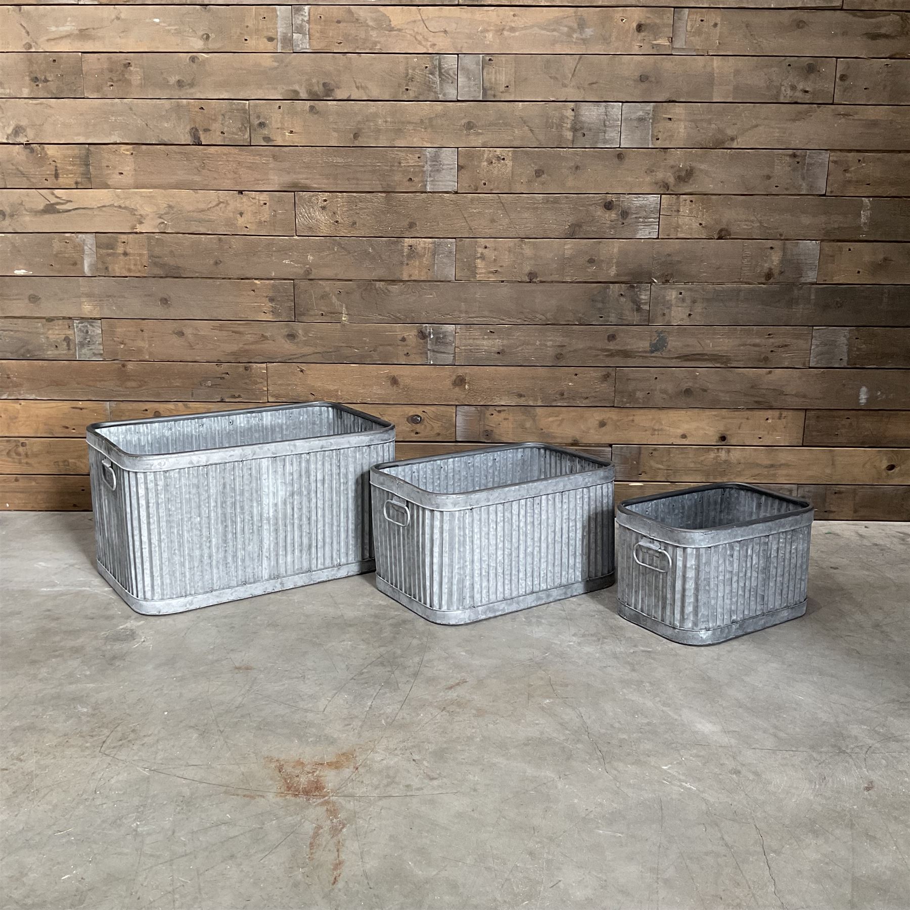 Set of three pressed metal planters in different sizes