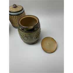 A group of Doulton Lambeth and Royal Doulton tobacco jars, to include examples with relief moulded foliate decoration, each with impressed marks and markers monograms beneath. 