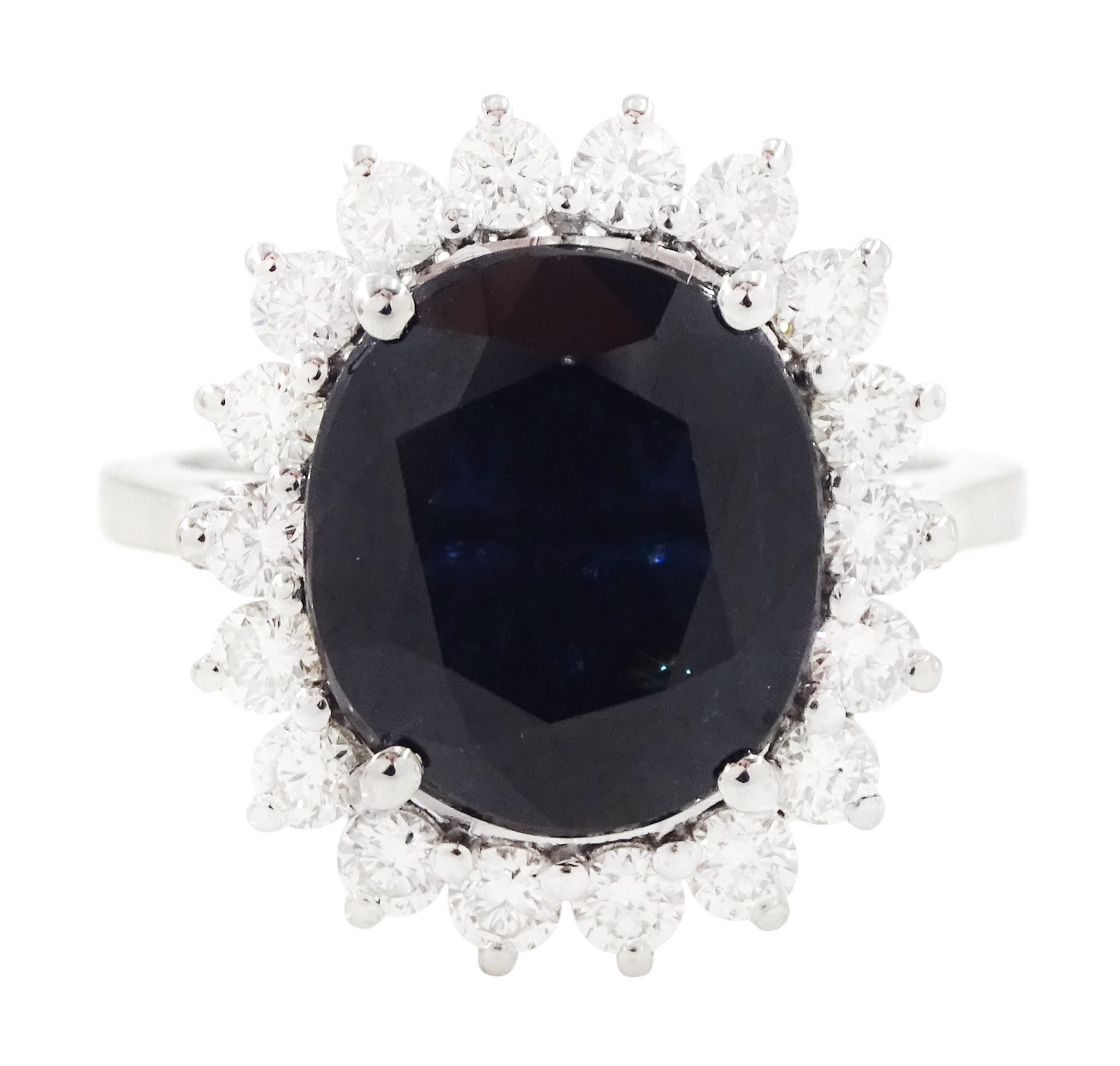 18ct white gold sapphire and diamond cluster ring, single oval cut sapphire of approx 4.30 carat, sounded by eighteen round brilliant cut diamonds, stamped, total diamond weight approx 0.75 carat
