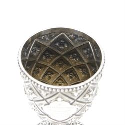 Victorian silver trophy cup or goblet, the cup with personally engraved quatrefoil panel and beaded rim, upon a knopped flower head detailed stem and spreading circular foot, embossed throughout with a flower head diamond trellis pattern, hallmarked Robert Hennell III, London 1860, H18cm