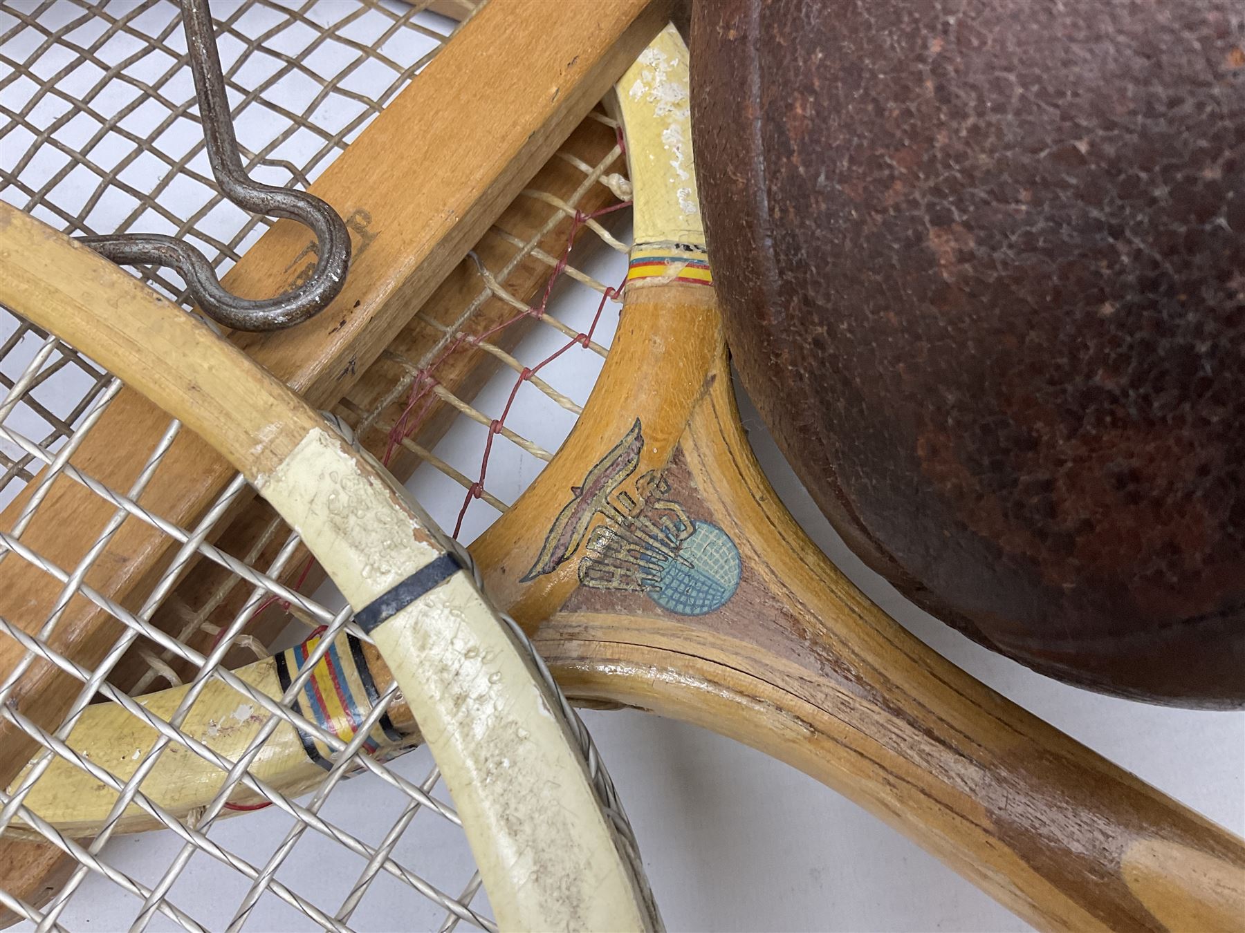 Quantity of early 20th century and later tennis rackets, to include Artus Majesty, Dunlop Alpha, Atlas Silver Shield and Raleigh Konni, together with a stitched rugby ball