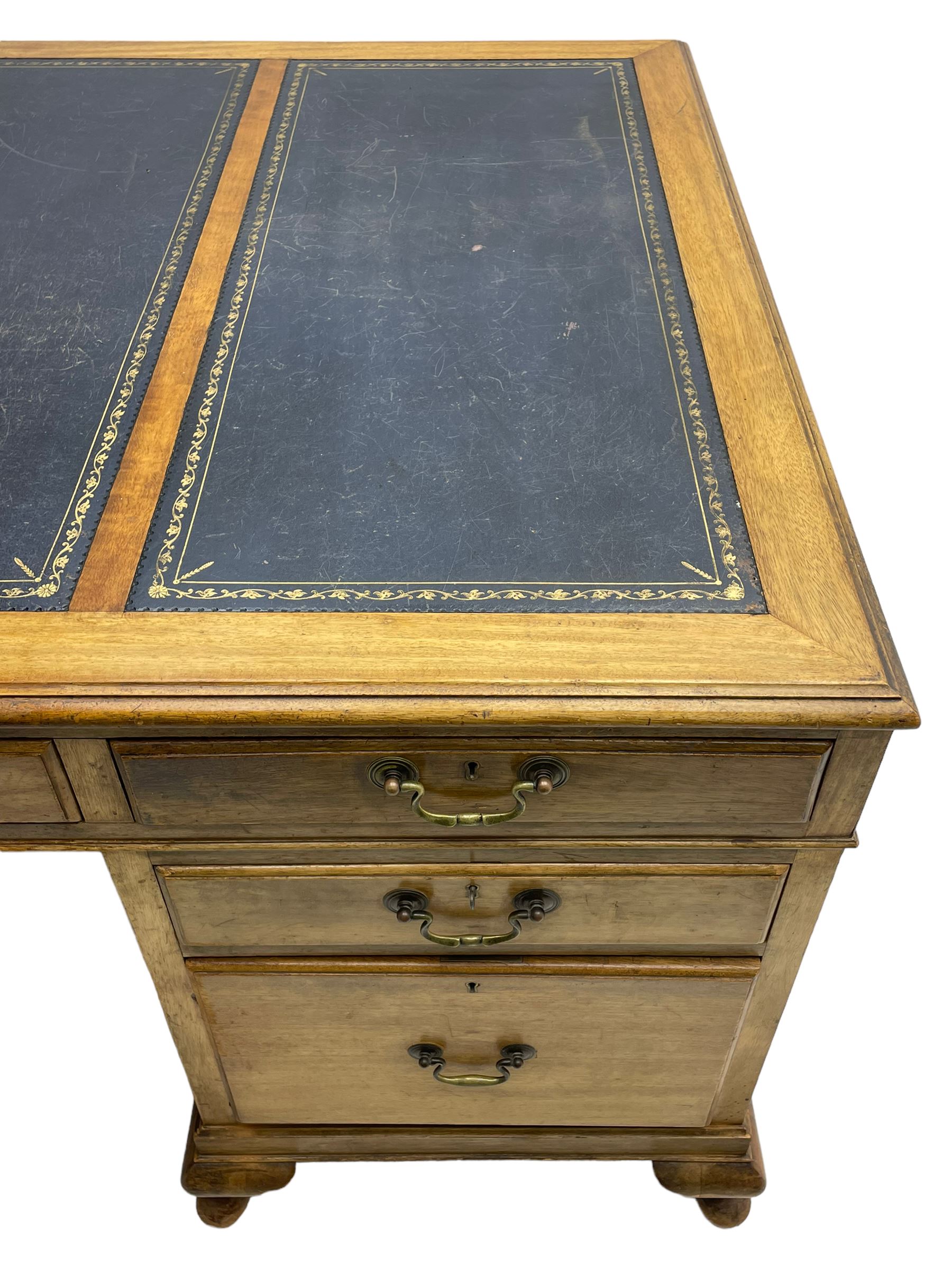Early 20th century mahogany twin pedestal desk, the moulded rectangular top with three sectional leather insets with gilt decoration, fitted with eight drawers, on cabriole feet