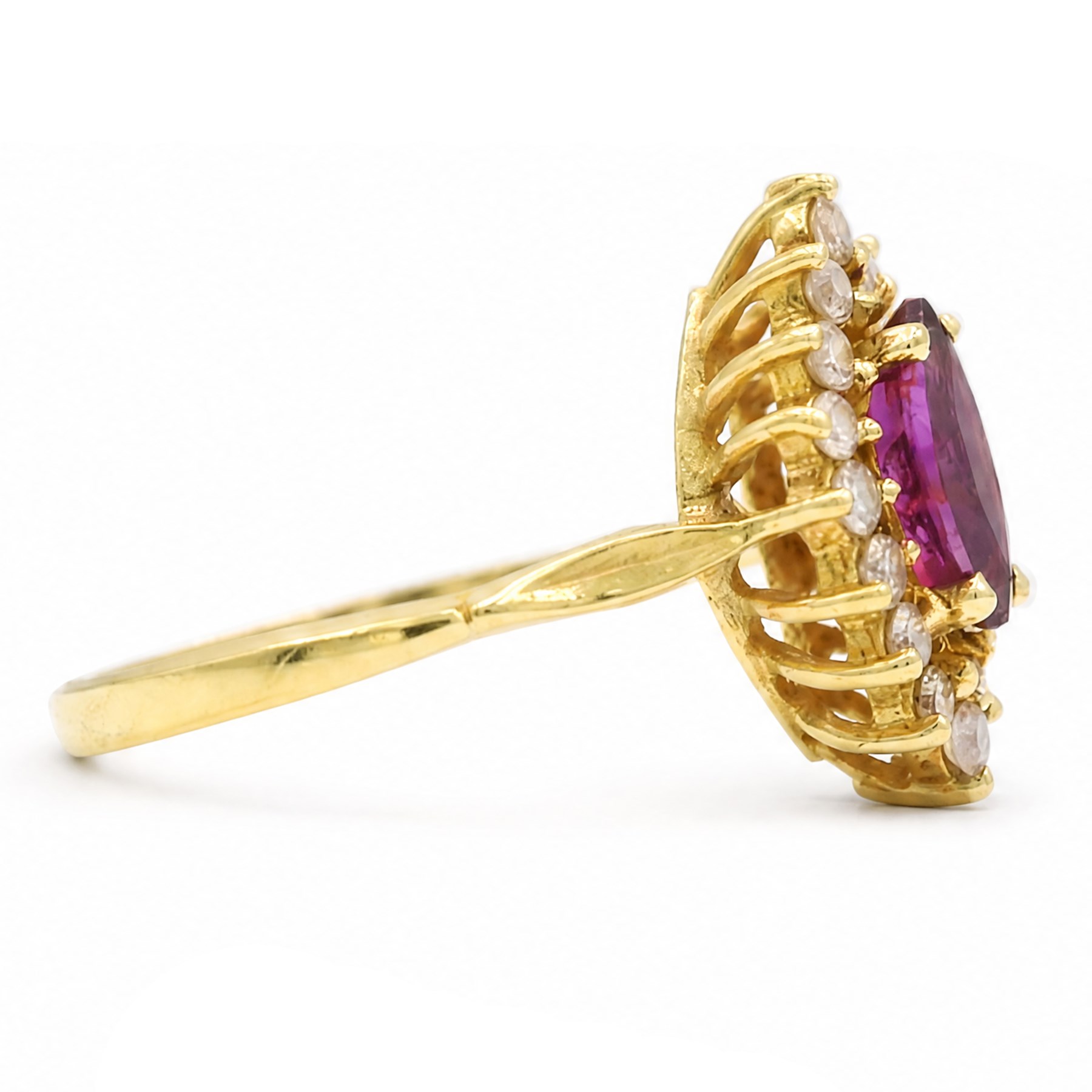 18ct gold ruby and diamond cluster ring, single marquise cut ruby of approx 0.90 carat, surrounded by sixteen round brilliant cut diamonds, stamped 750