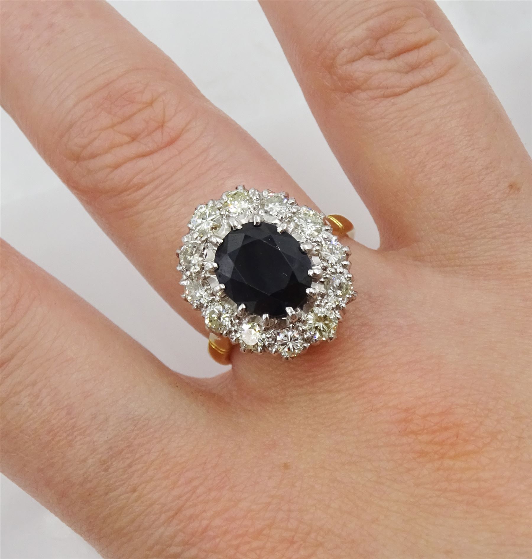 18ct gold and platinum oval sapphire and round brilliant cut diamond cluster ring, stamped, sapphire approx 2.80 carat, total diamond weight approx 1.00 carat and a 9ct gold band, hallmarked