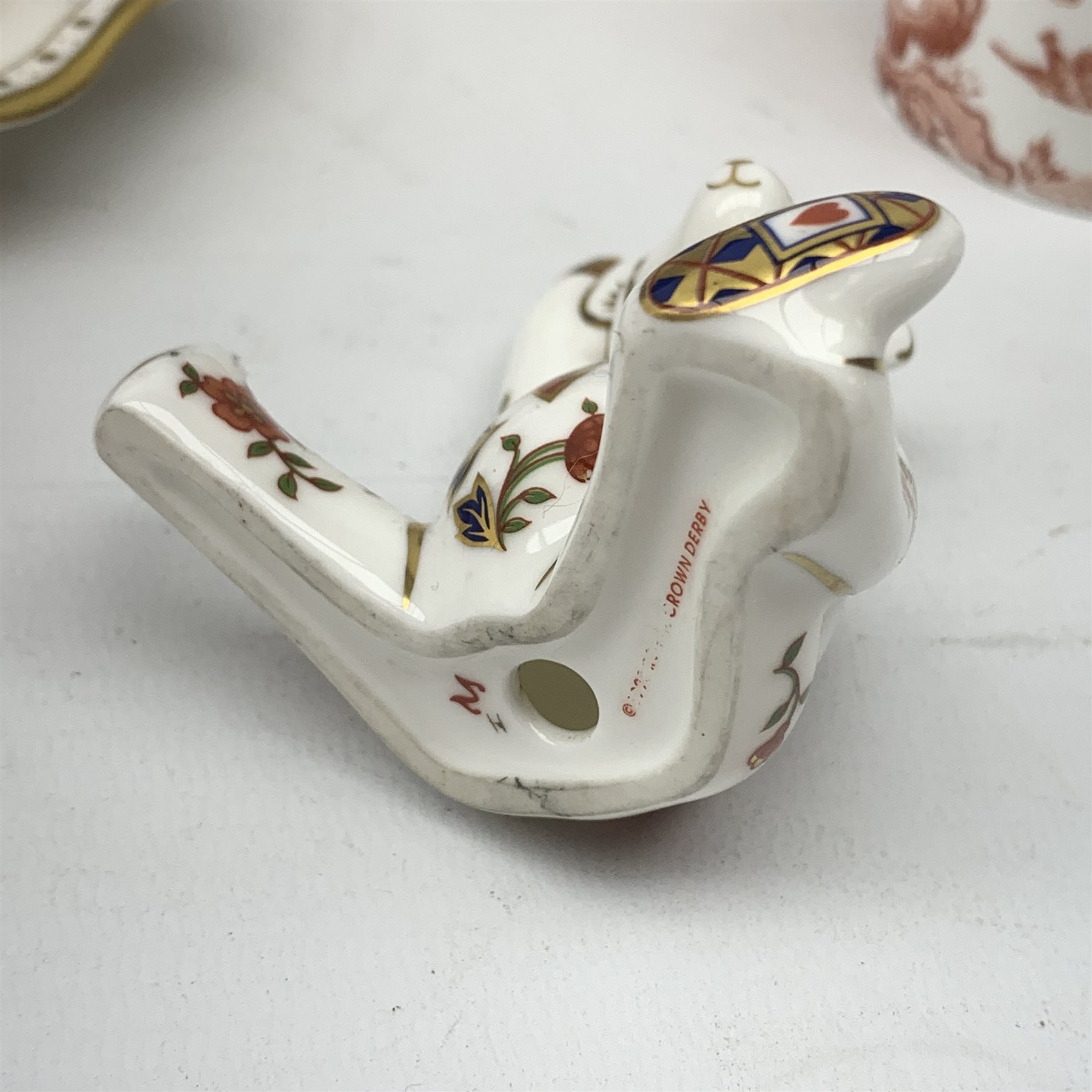 A selection of assorted Crown Derby, comprising three Mikado pattern dessert plates, D21.5cm, a Blue Aves pattern dish, a small Red Aves beaker, a Gold and Red Aves twin handled soup bowl with heraldic border, a small Royal Antoinette pattern plate, small commemorative dish, and a paperweight modelled in the form of a teddy bear (lacking stopper). 