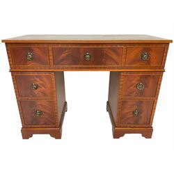 Music system in the form of a Georgian design twin pedestal desk, the reed moulded rectangular top hinges to reveal Garrard turntable with Dynatron Amplifier, fitted with speakers enclosed by two doors disguised as drawers, on bracket feet