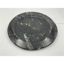 Pair of circular plates and oblong platter, each with Orthoceras and Goniatites inclusions, platter L30cm, plates D25cm
