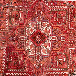 North West Persian Heriz hand-knotted carpet, madder red field, with a large central angular star medallion with stepped outlines on ivory ground, surrounded by geometric floral devices and stylized rosettes, with corresponding corner spandrels, enclosed by a bold geometric main border with multiple guard stripes, with cotton fringe ends 