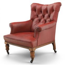 Early 20th century style oxblood red leather Chesterfield armchair, deep buttoned shaped b...