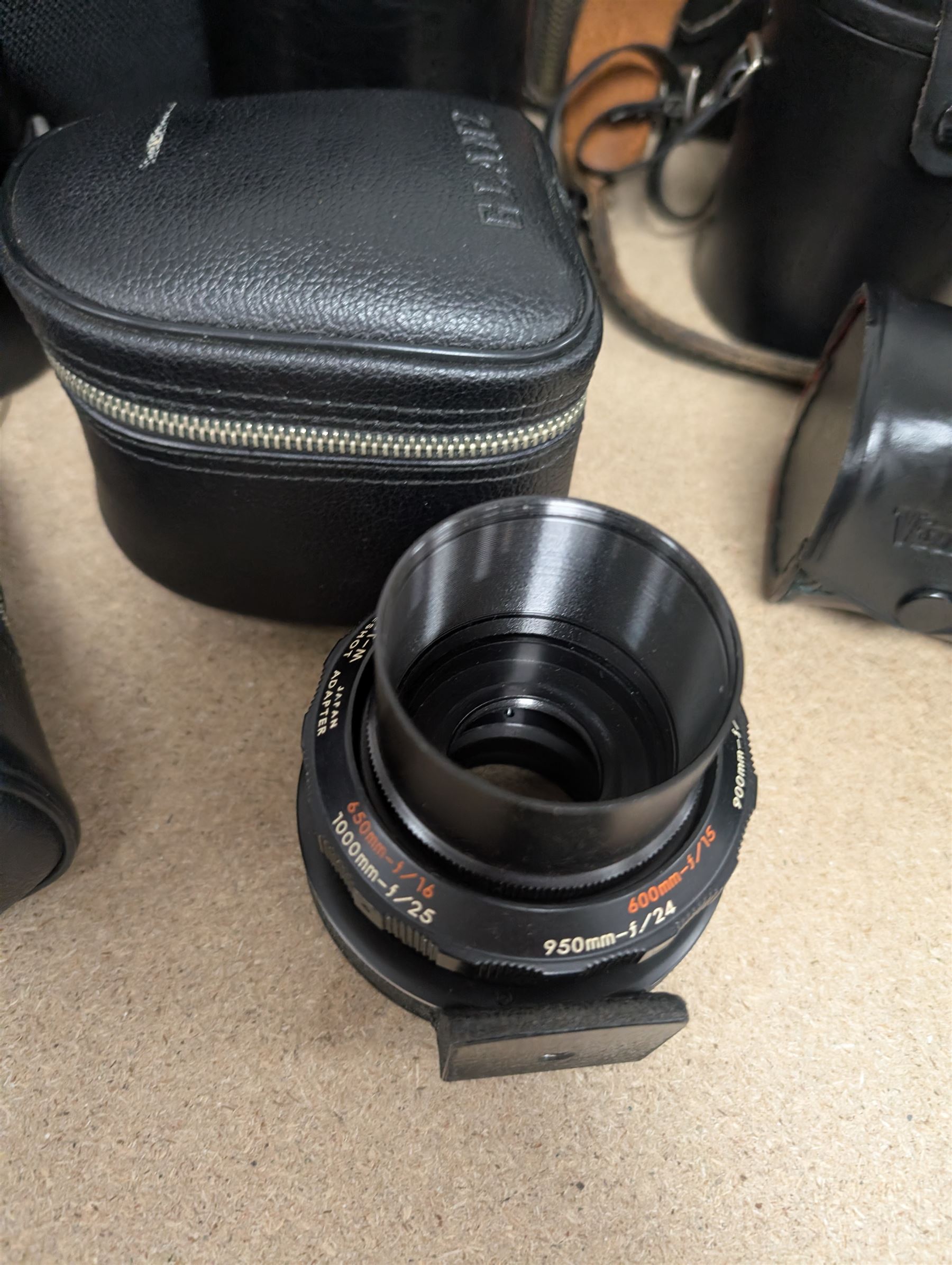 Kodak Dakon II folding camera and a collection of camera lenses and accessories, including Reflex-Nikkor  1:8 f=500mm, NikoN AF Nikkor 70-300mm 1:4-5.6G, Micro TM monocular lens and Teleshot adapter, two cases, Weston exposure meter, two cases etc