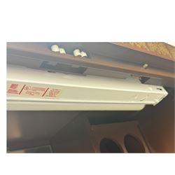 Chinese brown lacquered cocktail cabinet, decorated with gilt scenes of a traditional landscape with figures, pagodas, and mountainous scenery, double doors opening to reveal fitted interior with mirrored back, wine rack, shelves and cupboard, raised on square supports