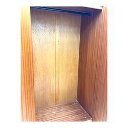 William Lawrence - mid-20th century teak double wardrobe, upper storage section over twin doors featuring recessed handles and contrasting horizontal panel, enclosing a hanging rail compartment, on plinth base with concealed castors