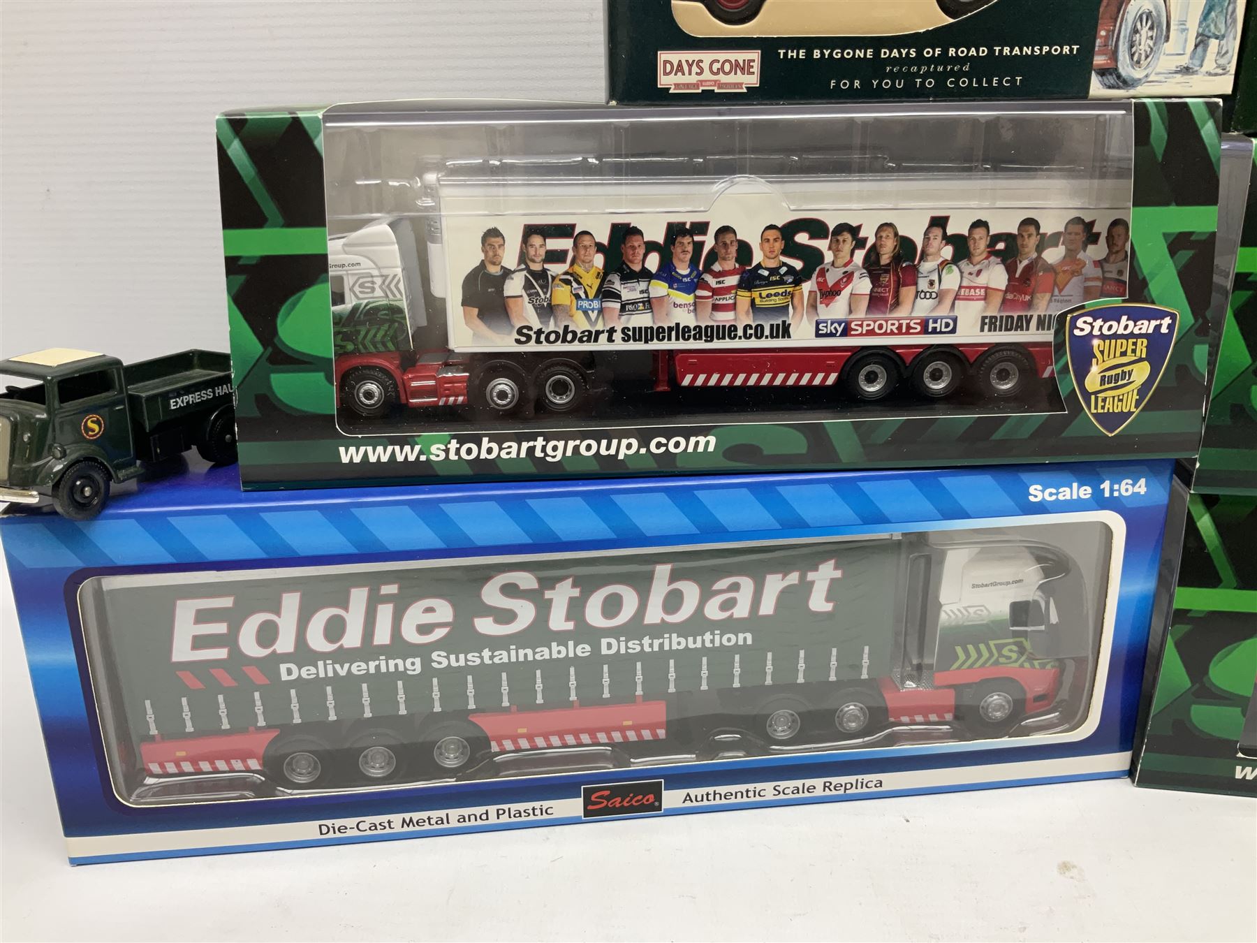 Eddie Stobart - three Oxford Die-Cast Super Rugby League lorries in perspex display cases including the two Hull Clubs; two Lledo Vanguard vans; two Days Gone vans; and Saico Truck & Trailer; all boxed; together with fourteen unboxed Corgi and other tractor/cab units etc (23)