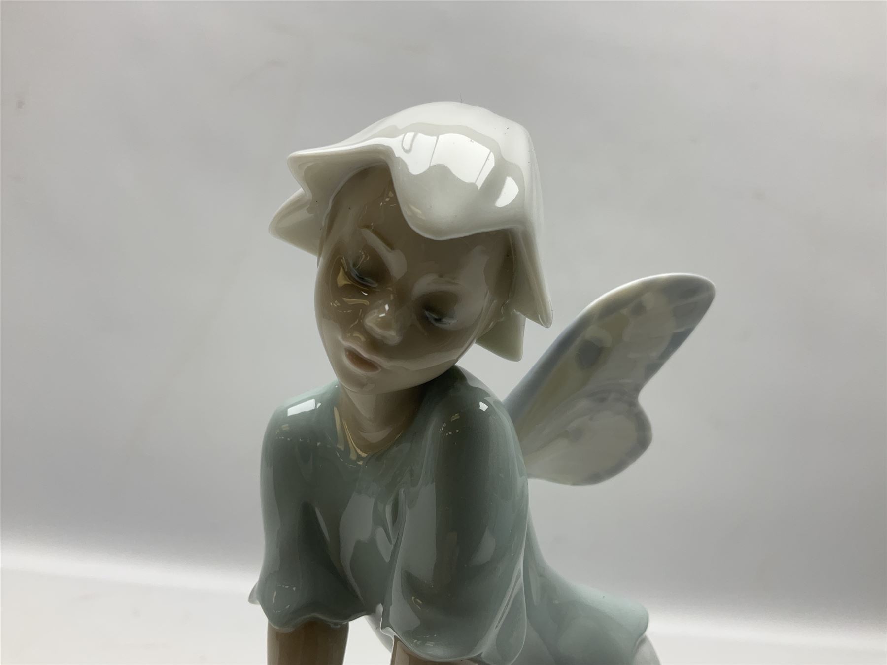 Lladro Privilege figure, Prince of Elves, modelled as an elf with wings leaning upon a rock, with original box, no 7690, sculpted by Joan Coderch, year issue 2001, year retired 2003, H23cm
