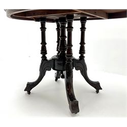 Edwardian inlaid walnut oval pedestal salon table, four turned supports joined by central finial on acanthus carved shaped supports 