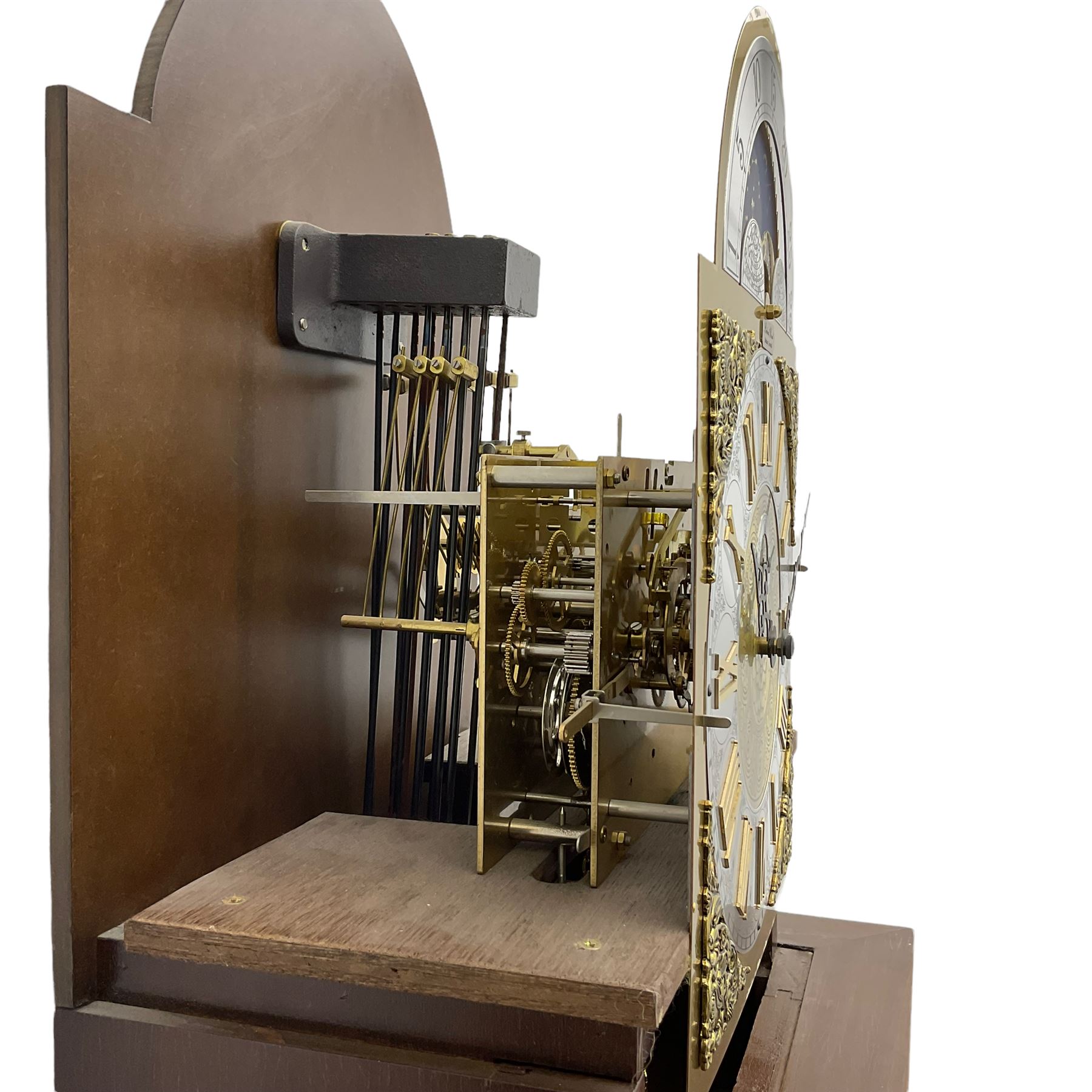 A  20th century longcase clock made to celebrate the millennium in the year 2000, this clock being No 2 of only 200 manufactured by  Richard Broad in Bodmin Cornwall, with a mahogany effect case and traditional swans neck pediment with three brass finials, break arch hood door on a trunk with recessed columns and full length glazed door, on a square plinth with inlay and a shaped base, brass dial with brass spandrels, silvered chapter ring, seconds dial and working moon phase to the arch, weight driven three train movement striking the quarters and hours on 12 gong rods, with a choice of St Michael, Westminster and Wittington chimes, with chime selector and chime/silent facility. With three brass cased weights and gridiron pendulum.





