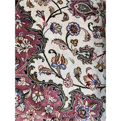 Finely knotted Persian Qom silk rug, overall pink ground with ivory field, the field with central cusped medallion profusely decorated with interlacing foliate and stylised flower heads, multiple band boarder, the main band decorated with a series of stylised motifs and trailing foliage, the outer guard with signature panel 