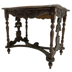 19th century walnut centre table, shaped top carved with central cartouche and extending scrolled foliage, the shaped frieze rails carved with scrolling acanthus leaves, turned supports with central end supports carved with flower heads and scrolls, curved x-framed stretcher carved with a central mask depicting a girl in a bonnet, on turned and carved feet