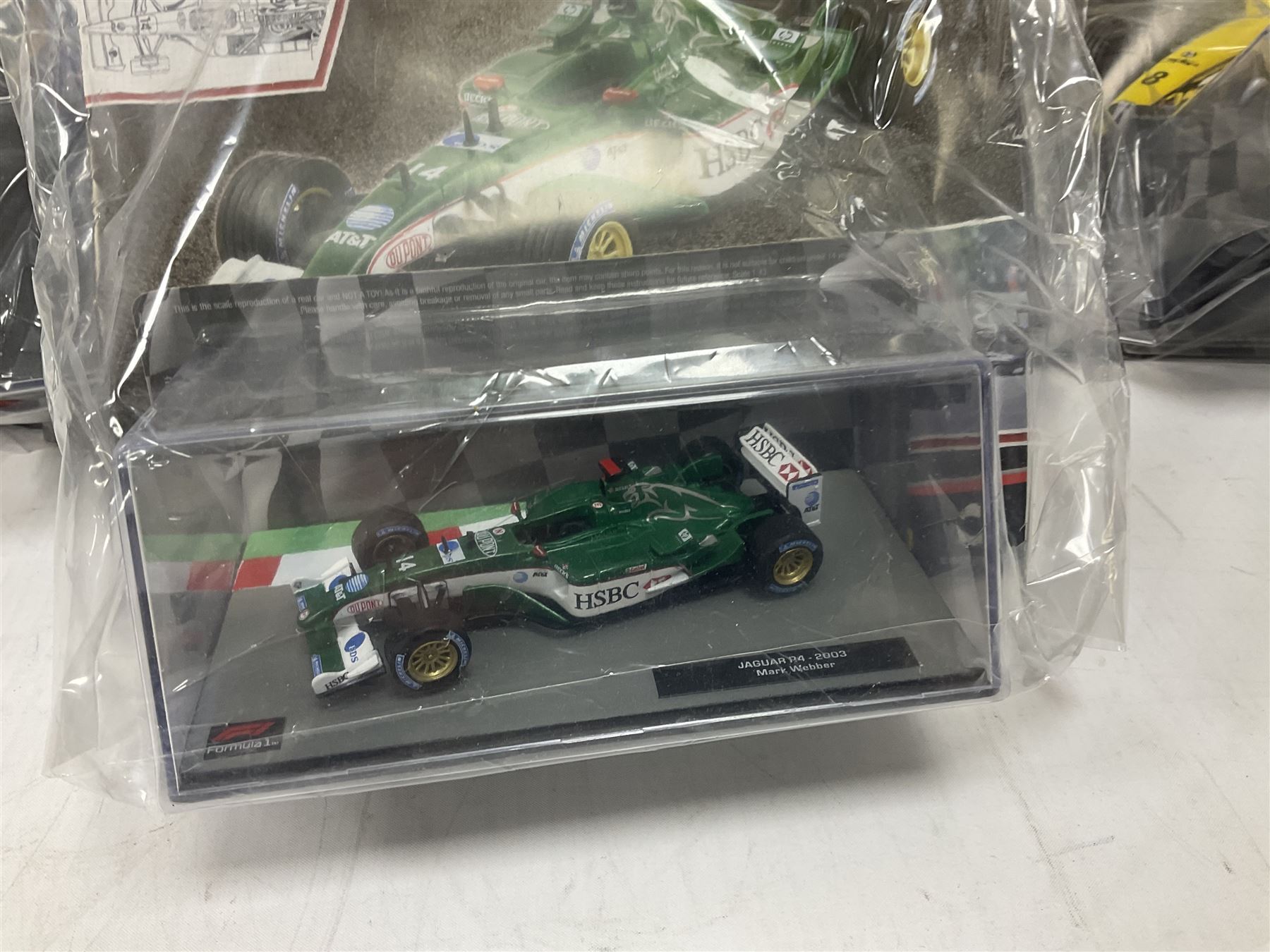 Panini Formula 1 The Car Collection - twelve die-cast models including ten in unopened packaging with periodical; all models in plastic display boxes; and eight other boxed die-cast models of racing cars by Corgi, Onyx, Classico, Minichamps etc (20)