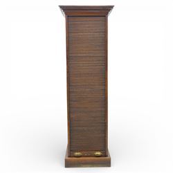 Edwardian oak pedestal office cabinet, moulded rectangular top over tambour shutter enclosing fitted interior, with fifteen graduated drawers each with recessed brass cup handle and label holders, panelled sides, on plinth base