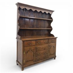 Georgian design oak dresser, the raised plate rack with shaped sides and two open shelves, upon a dresser base fitted with six drawers and two cupboard doors, and short block feet 