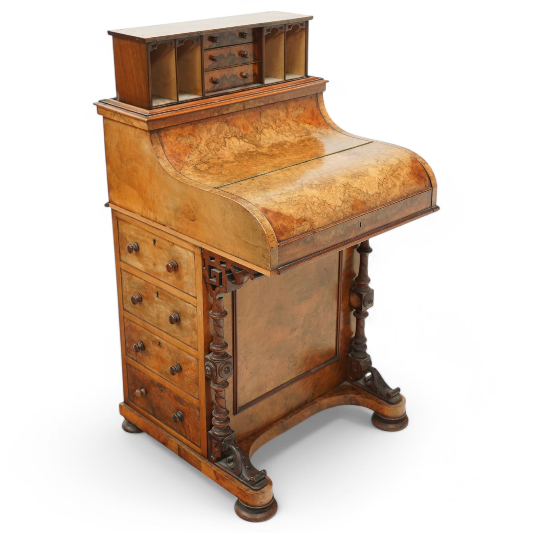 Victorian figured walnut piano top Davenport desk, hidden compartment lifting to reveal small drawers and pigeonholes, the piano lid enclosing drawers and sliding top with hinged leather writing surface, the right-hand side fitted with four drawers, on compressed bun feet 