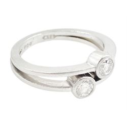 Platinum bezel set, two stone round brilliant cut diamond, crossover ring, London 1985, total diamond weight approx 0.50 carat
