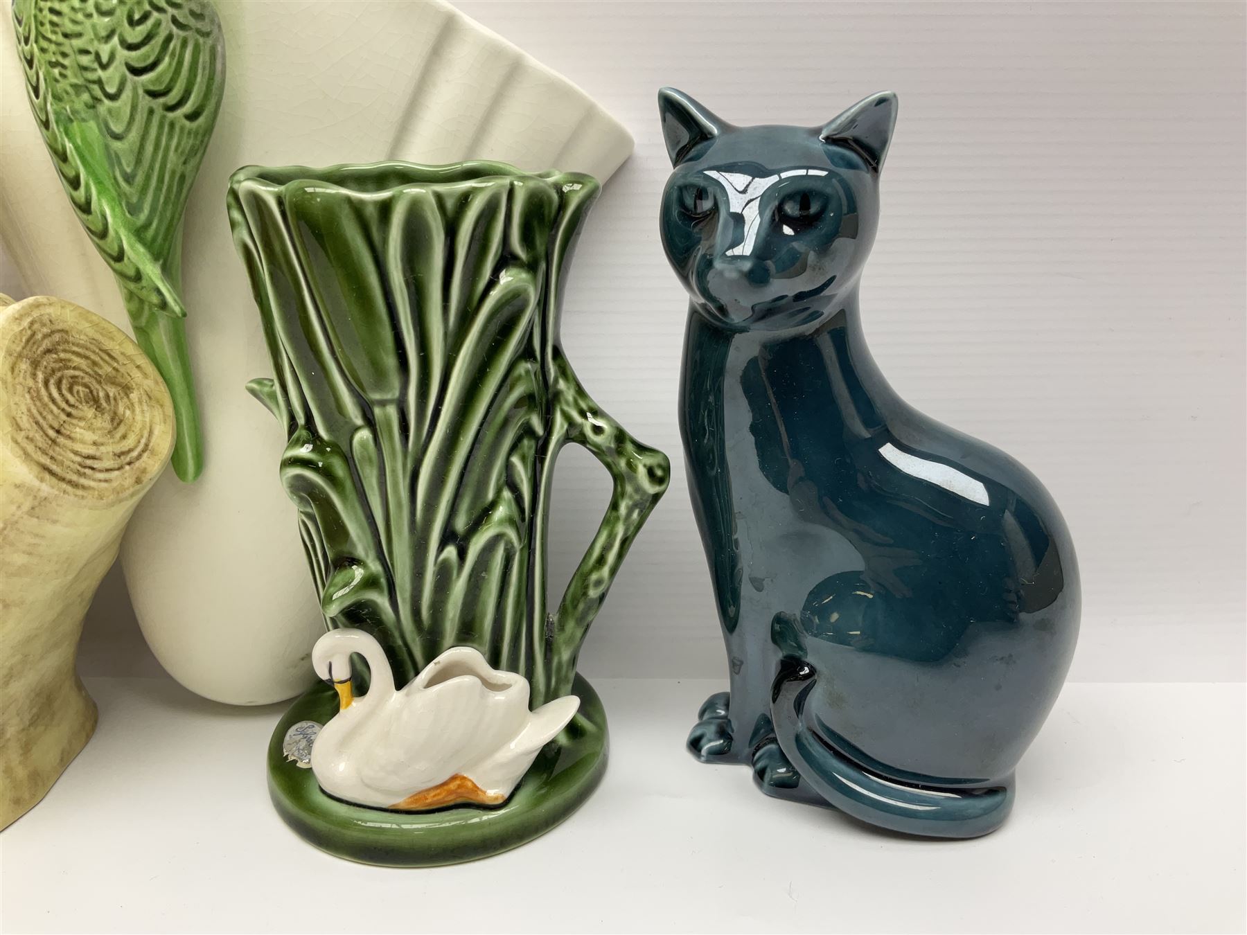 Sylvac budgieregar wall pocket, together with other Sylvac cermics including swan vases, blue tit vase and a frog figure etc, all with printed or impressed marks beneath, and a Poole Pottery cat figure, with printed mark beneath, wall pocket H22cm