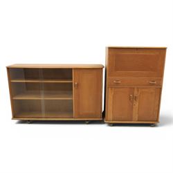 Mid-20th century elm and beech drinks cabinet with fall-front, with matching low bookcase...