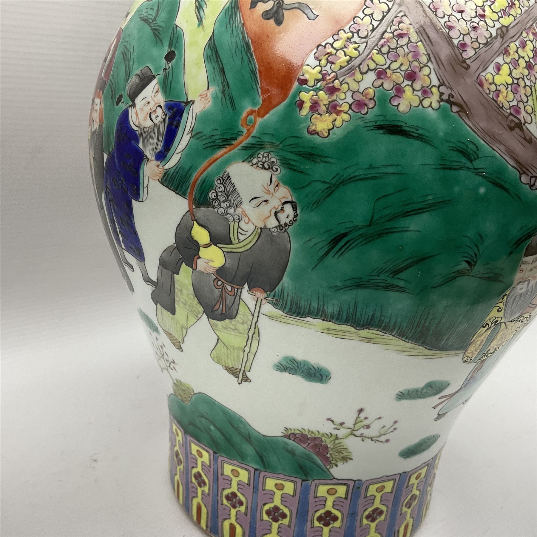 20th century Chinese Famille Rose vase, of baluster form with flared lobed rim and twin figural handles, decorated in polychrome enamel with figures dancing and playing instruments within a garden setting, H42cm