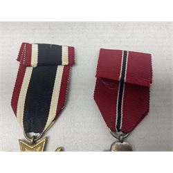 Two WW2 German medals - Winter Campaign in Russia 1941-42 and War merit Cross with swords; both with ribbons (2)