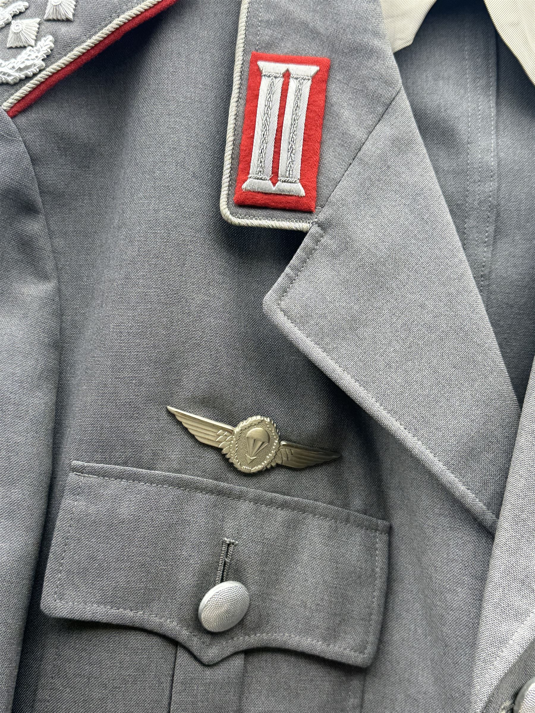 West German helmet steel helmet, together with 1960's peak cap and tunic with German insignias 