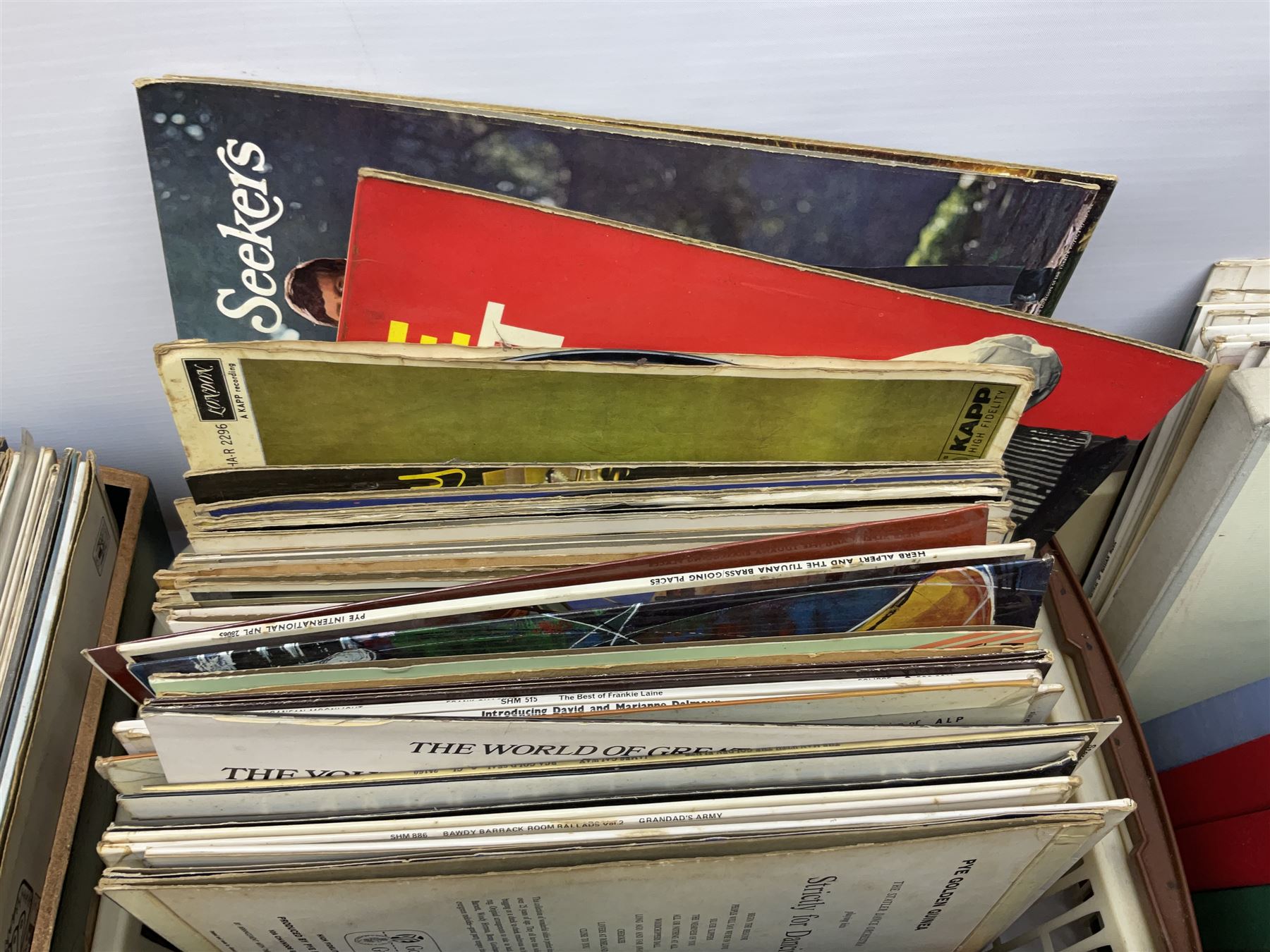 Wooden magazine rack, with floral detail, together with a collection of records, to include the box sets 'the Story of Great Music', 'Popmobility', Happy Holiday in Greece  etc, in three boxes 
