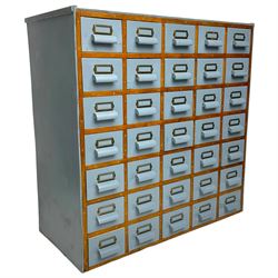 Mid-20th century multi-drawer chest or filing cabinet, fitted with thirty-five small drawers with wooden handles and metal label holders, in light blue paint finish 