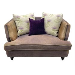 John Sankey - two-seat contemporary shape hardwood-framed snuggler sofa, upholstered in leather and fabric with contrasting scatter cushions in pale ground fabric decorated with thistles, on turned front feet