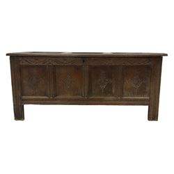 18th century oak coffer or chest, rectangular hinged panelled top with moulded frame enclosing candle box, the frieze carved with foliate S-scrolls over a quadruple panel front decorated with carved lozenges, on stile supports