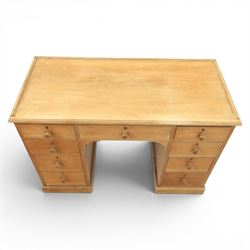 20th century ash twin pedestal desk, gadroon galleried top, twin bank of graduated drawers, plinth base