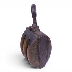 19th century double-sheave wooden pulley block in a metal casing, fitted with an iron hook, stamped GIS to one side, including hook L36cm