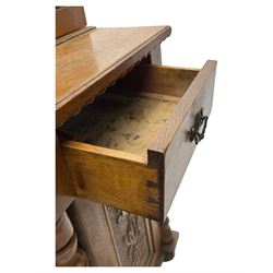 Late 19th century pine dresser, the projecting cornice with dentil and spindle moulded frieze above a three-tier plate shelves, flanked by glazed doors, the base fitted with three frieze drawers over arched apron and carved floral panelled cupboard doors, raised on turned feet