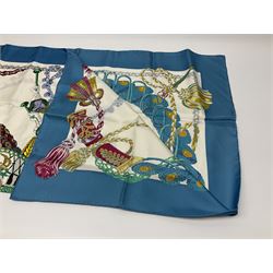 Hermès 'Le Timbalier' silk scarf, designed by Francoise Heron in 1961, printed with a central image of a gentleman on horseback donning extravagant dress, on white ground surrounded with colourful stylised knotted ropes, contained within peacock blue border, with rolled hand stitched edges and Hermes material label, 87cm square