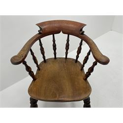 Early 20th century elm smokers bow captains chair, turned supports joined by double ’H’ stretcher 