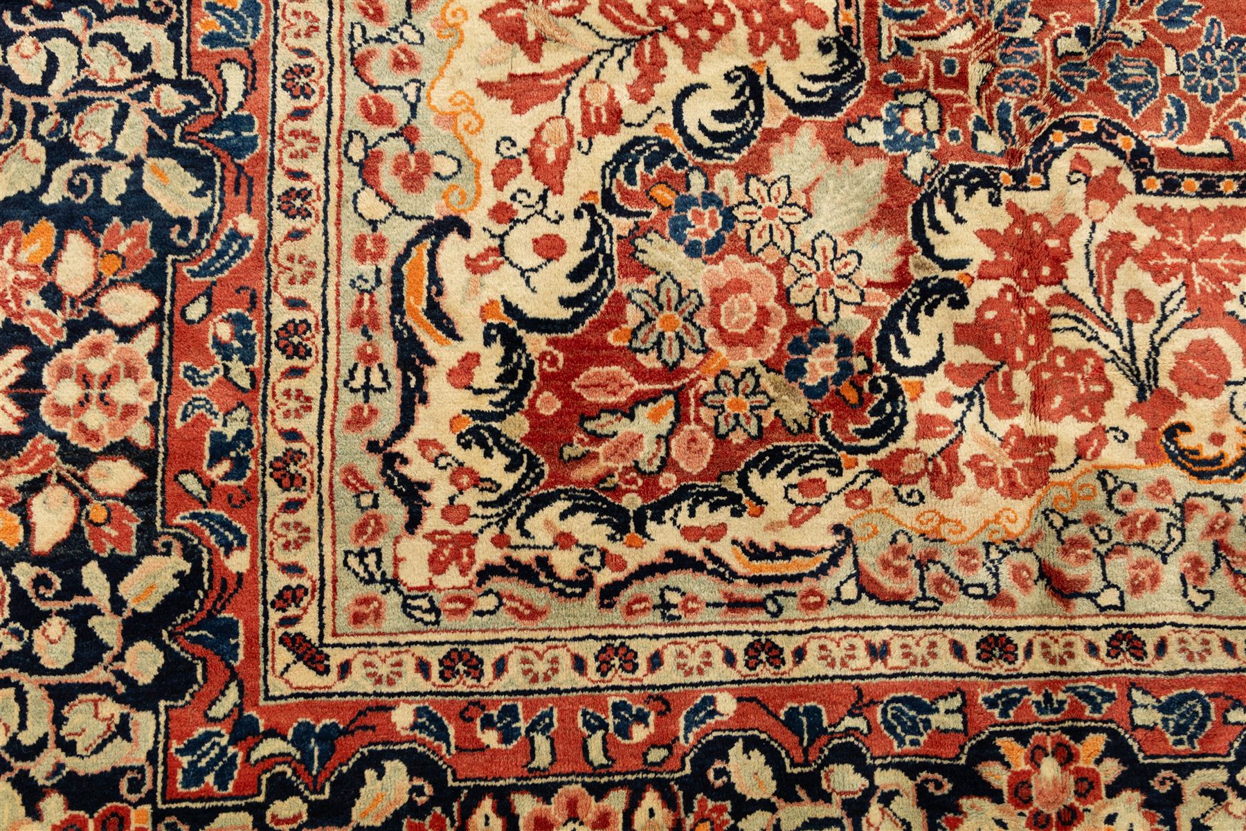West-Central Persian Mahal hand-knotted carpet, terracotta field with a large central indigo and ivory medallion with floral palmettes and scrolling vines, framed by ivory spandrels with dense foliage within a broad navy border of lotus and palmette motifs linked by scrolling tendrils and multiple guard stripes 