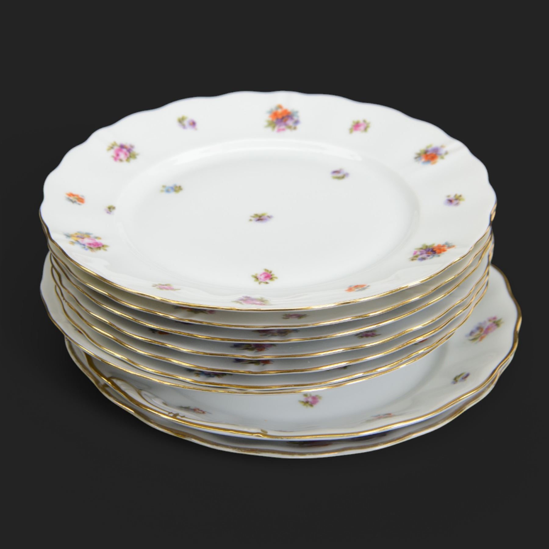 Forstenberg part tea and dinner service, comprising teapot, teacups and saucers, dinner plates, tureens, sauce boat, lidded sugar bowl, side plates and serving plates, all decorated with polychrome floral sprigs on a white ground with gilt edging