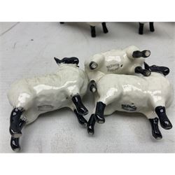 Seven Beswick figures of sheep comprising three ewes and four lambs, together with a figure of a sheepdog (8)