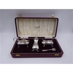 Modern silver three piece cruet set, comprising pepper, mustard pot and cover with blue glass liner, open salt with blue glass liner, and salt spoon, each with oblique gadrooned rim, hallmarked William Suckling Ltd, Birmingham 1961 and 967, contained within a fitted case with burgundy velvet and cream silk lined interior, approximate total silver weight 7.09 ozt (220.5 grams)