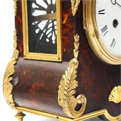 French-late 19th century brown stained 8-day faux Tortoise shell and ormolu mounted mantle clock, rectangular case with glazed side panels and shaped pediment with matching finials, convex enamel dial with Roman numerals, minute track and steel moon hands within a cast brass glazed dial bezel,
twin barrel movement with rack striking, striking the hours and half hour on a coiled gong. With pendulum and key.