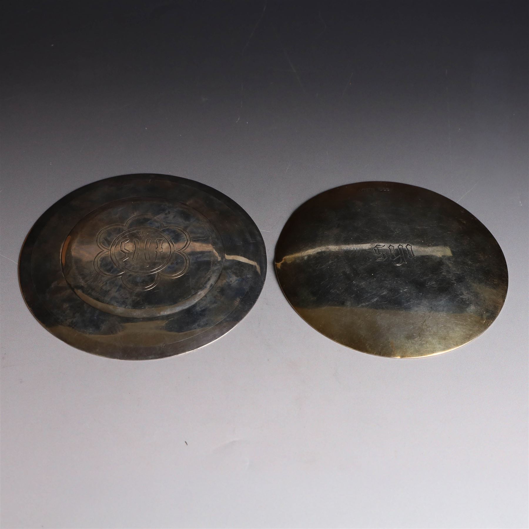 Two silver-gilt patens, comprising French silver example, of typical flatted circular form, engraved IHS to underside, with Minerva's head mark to one side and a 1960s example of similar form engraved IHS to underside, hallmarked Pepper & Hope Ltd, Birmingham 1967, largest D12.5cm